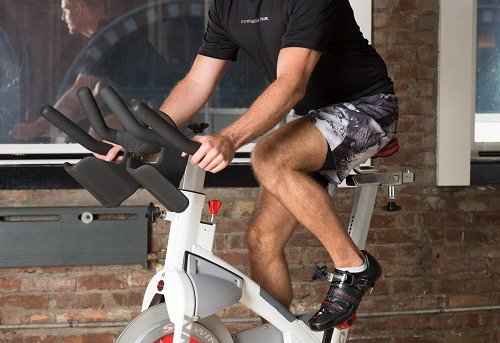 Body situating while at the same time utilizing the exercise bike